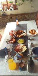 a table with food and plates of food on it at Kétkerék Vendégház - a mátrai szállás in Matraszentlaszlo