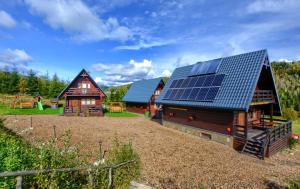 a house with solar panels on the side of it at Jakubowy Domek in Cisna