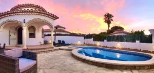 a villa with a swimming pool and a house at Villa Sonrisa de Oro - private swimming pool in Miami Platja