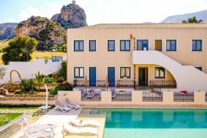 a villa with a swimming pool and a house at Hotel Baglio Di Scopello in Scopello