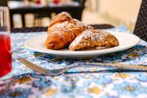 two croissants on a plate on a table at Hotel Baglio Di Scopello in Scopello