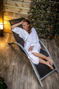 a woman laying in a bed on the floor at Suite SPAtio - Jacuzzi Privé - 20min Disneyland PARIS in Pézarches