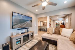 a living room with a couch and a flat screen tv at Gem 3 in Jacksonville Beach