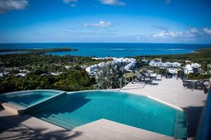 a swimming pool with a view of the ocean at Happy Days Villa A in Fajardo