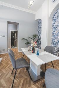 a living room with a table and chairs at Basilica Apartments in Budapest