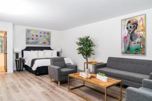 a living room with a bed and a couch at Essex House Hotel in Miami Beach +23 photos