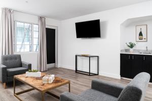 a living room with a couch and a table at Essex House Hotel in Miami Beach