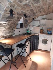 een keuken met een tafel en een wasmachine bij Cantina antica in Colonno