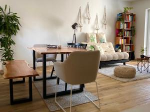 a living room with a table and a couch at StylishHomes NEST - A Cosy Adventure in Frauental an der Lassnitz 