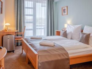 Postel nebo postele na pokoji v ubytování Szent János Hotel