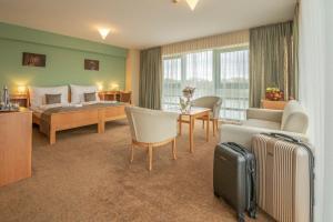 Postel nebo postele na pokoji v ubytování Szent János Hotel