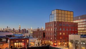 a view of a city at night with buildings at Wythe Hotel in Brooklyn