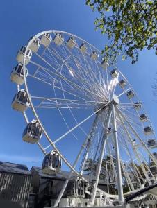 a ferris wheel in front of a blue sky at Isabela Apartments in Palanga