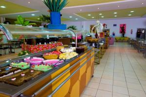 una línea de buffet en un centro comercial con muchas comidas diferentes en Golden Dolphin Roberto Imóveis, en Caldas Novas