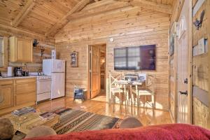 a kitchen and dining room with a large television in a cabin at Rivers View - Cherokee Lake Cabin with Fire Pit! in Bean Station