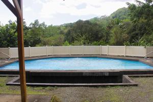 a large swimming pool with a fence around it at Casa Danta in Quepos