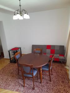 a table and chairs in a room with a couch at Saburtalo Apartment Tbilisi in Tbilisi City