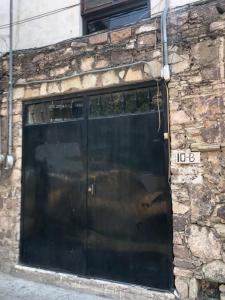 a large black garage door on a stone building at Hotel Corazón de Plata Centro in Guanajuato
