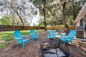 four blue chairs and a table in a yard at Honey Bee Hideaway in Fleming Island
