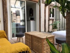 a room with a bed and a table on a balcony at T2 style cottage - Véranda & Terrasse extérieure in Tours