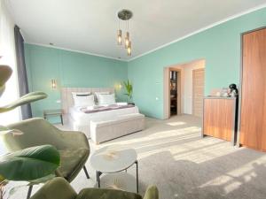 a bedroom with a bed and a couch and a chair at CoolKush Boutique in Constanţa +50 photos