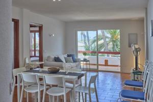 a living room with a table and chairs and a couch at Nura Houses Magaluf Apartment in Magaluf