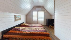 a bedroom with two beds in a attic at Saimaa Marina Garden Apartments in Lappeenranta