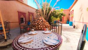 uma mesa com pratos e guardanapos num pátio em Kasbah Tussna em Boumalne