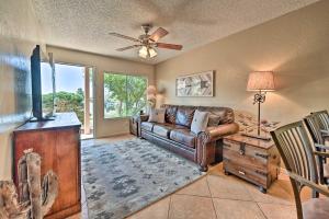 a living room with a leather couch and a tv at South Sedona Condo with Pool Access - Walk to Shops! in Sedona