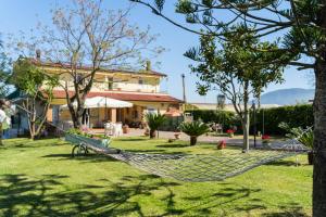 a hammock in a yard in front of a house at Villa Brunella in Agropoli