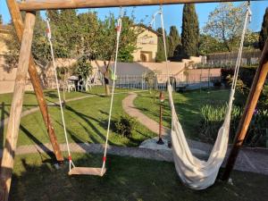 a couple of swings in a yard at PePe house in Capannori