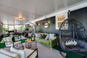 a living room with a green couch and swings at S'more Fun in Middleburg