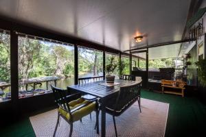 a dining room with a table and chairs and a river at S'more Fun in Middleburg