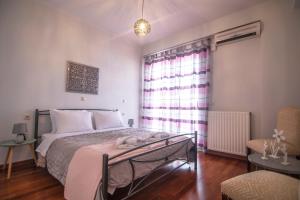 1 dormitorio con cama y ventana en Akrata's Elegant Luxury Suite en Akrata