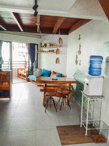 a kitchen with a table and chairs in a room at Flat Maui Beach- Com vista e de frente para o mar in Tamandaré