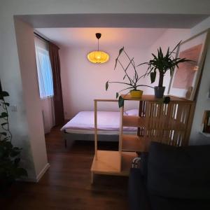 a bedroom with a bed and a table with plants at M37 x Fabryczna in Limanowa