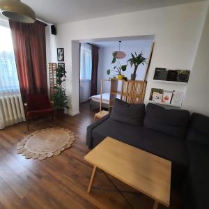 a living room with a couch and a table at M37 x Fabryczna in Limanowa