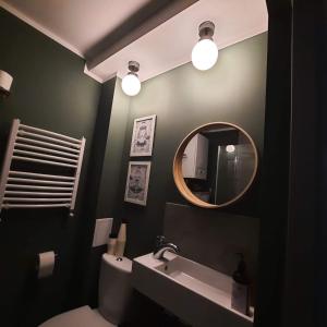 a bathroom with a sink and a mirror at M37 x Fabryczna in Limanowa