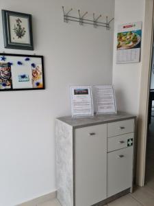 a counter in a room with signs on the wall at Beutlich's Wörtherseeappartements in Velden am Wörthersee +26 photos