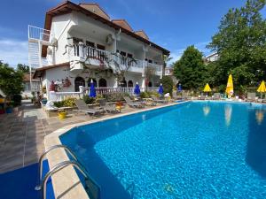 a swimming pool in front of a house at Casablanca Hotel in Dalyan