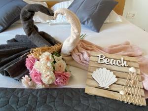 a bed with towels and flowers and swans on it at Villa Sun&Sea in Komarna +32 photos