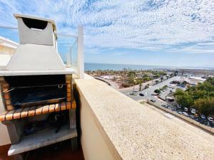 a kitchen hood on a balcony with a view of a city at Apartamento Arrecife in Arrecife