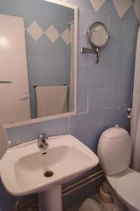 a bathroom with a sink and a toilet and a mirror at Sayadeen Village - Red Sea Riviera in Nuweiba