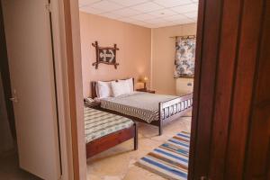 a small bedroom with a bed and a window at Sayadeen Village - Red Sea Riviera in Nuweiba