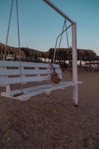 a swing on the beach with a guitar on it at Sayadeen Village - Red Sea Riviera in Nuweiba
