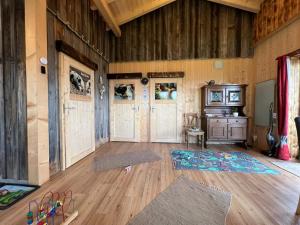 a room with wooden floors and wooden walls and doors at Gemütliches Häuschen "Bergblick Hollnhof" lädt zum verweilen ein in Donnersbach
