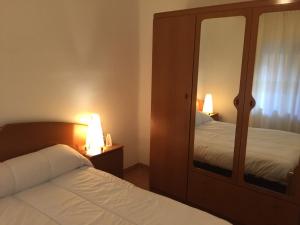 a bedroom with two beds and a mirror at Piso Zafer Alcora in Alcora