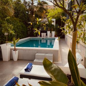 a swimming pool in a garden with plants at HIGH END WALK TO A BEACH PROPERTY in Split