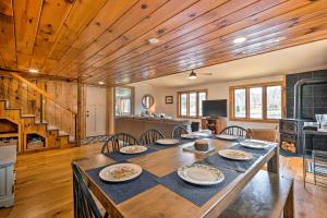 a dining room with a large wooden table with chairs at Cozy Castleton Cabin with Fire Pit and Water Access! in Castleton