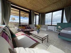 a living room with a couch and a table at Il Dammuso di Noto - Villa con Piscina privata in Avola +59 photos